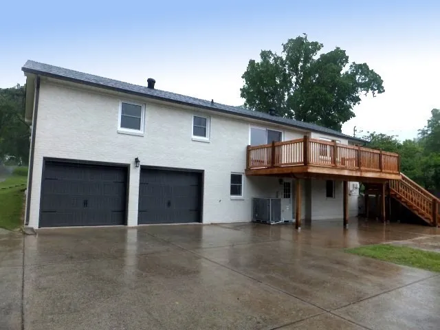 a view of a house with a backyard and a garage