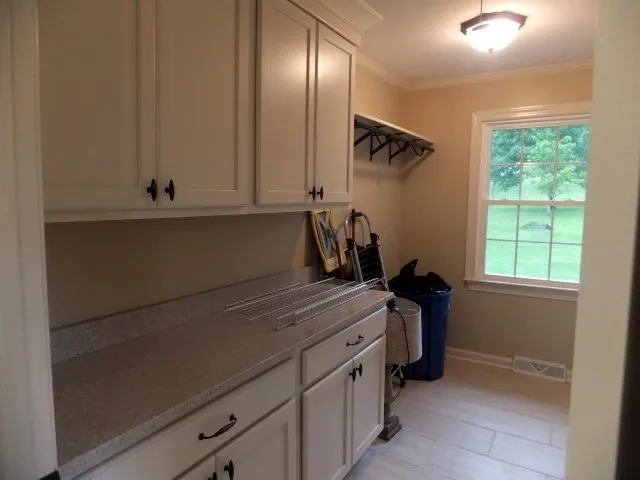 a view of storage and utility room with windows