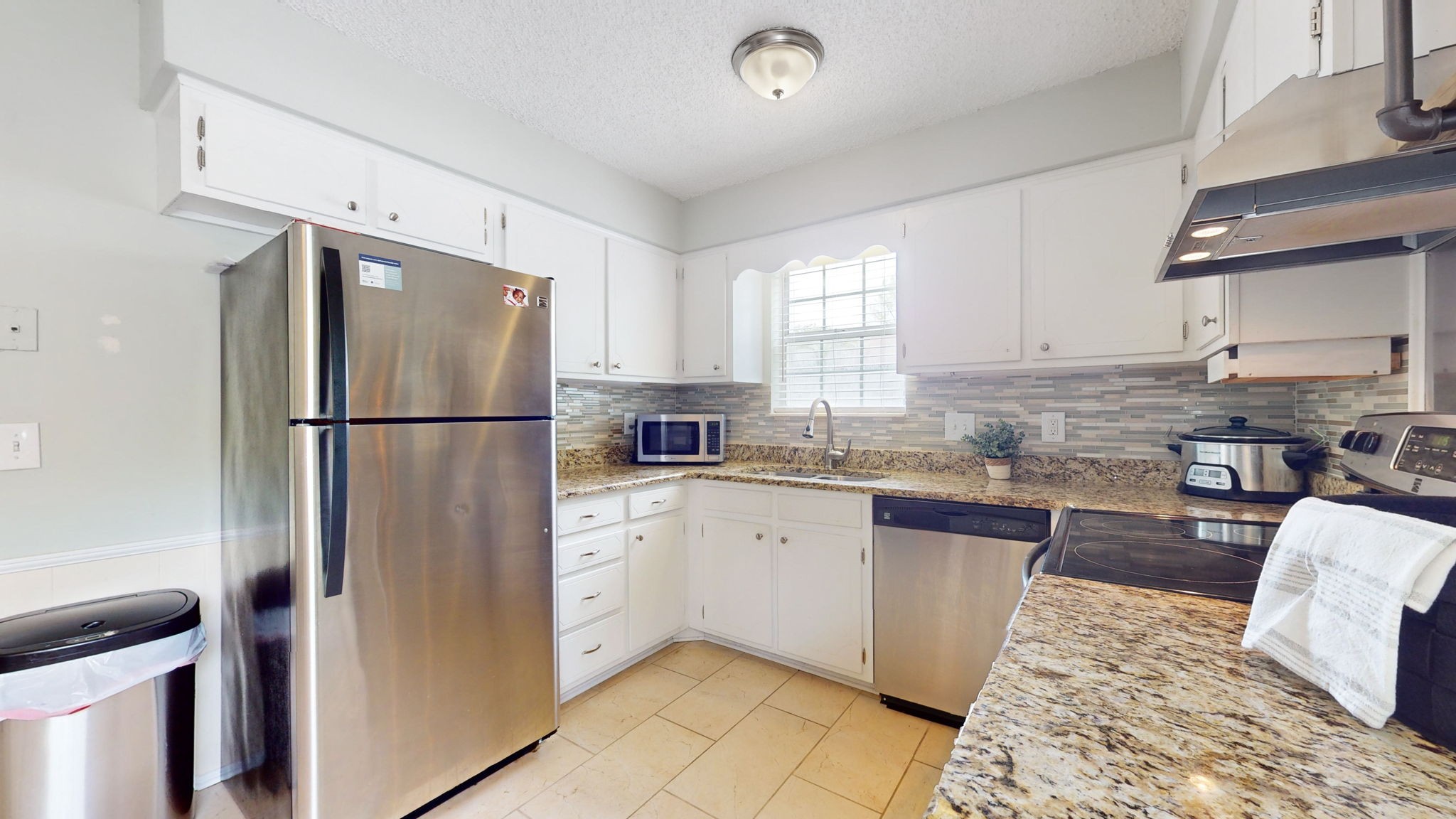 3229 New Towne Road Antioch, TN 37013 - Photo 10 of 35 a kitchen with stainless steel appliances granite countertop a refrigerator sink and stove