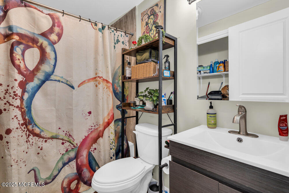 6 Mizzen Way Waretown, NJ 08758 - Photo 10 of 12 a bathroom with a sink a toilet and a mirror