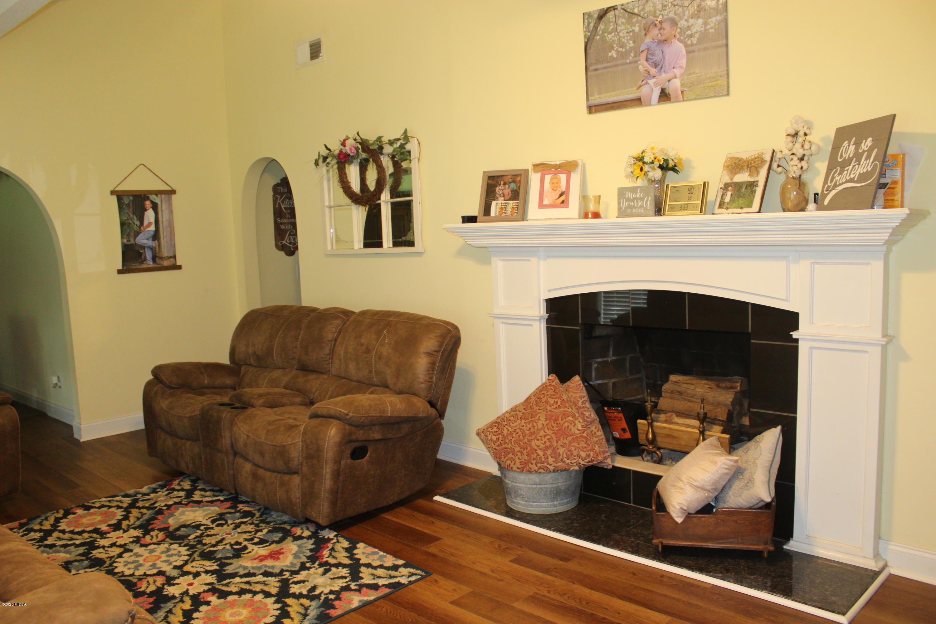 75 Jenkins Road Forsyth, GA 31029 - Photo 3 of 15 a living room with furniture and a fireplace