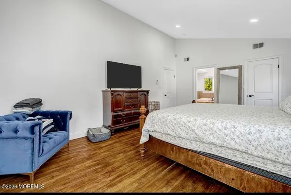 a bedroom with a bed and a chair