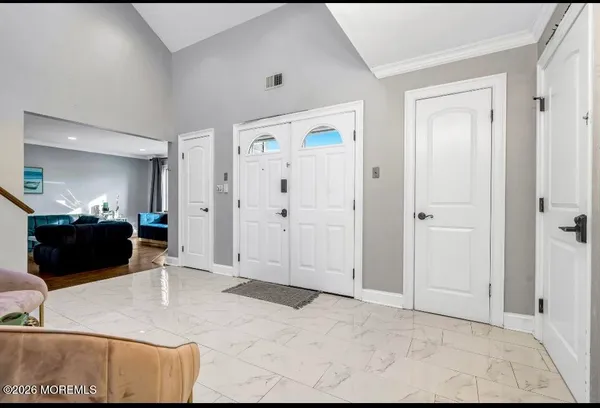 a bathroom with a granite countertop toilet a sink and a mirror