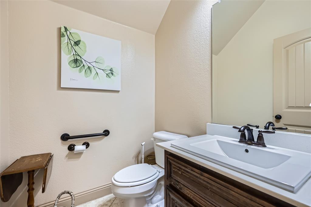 813 Goose Court Forney, TX 75126 - Photo 13 of 28 a bathroom with a sink mirror vanity and toilet