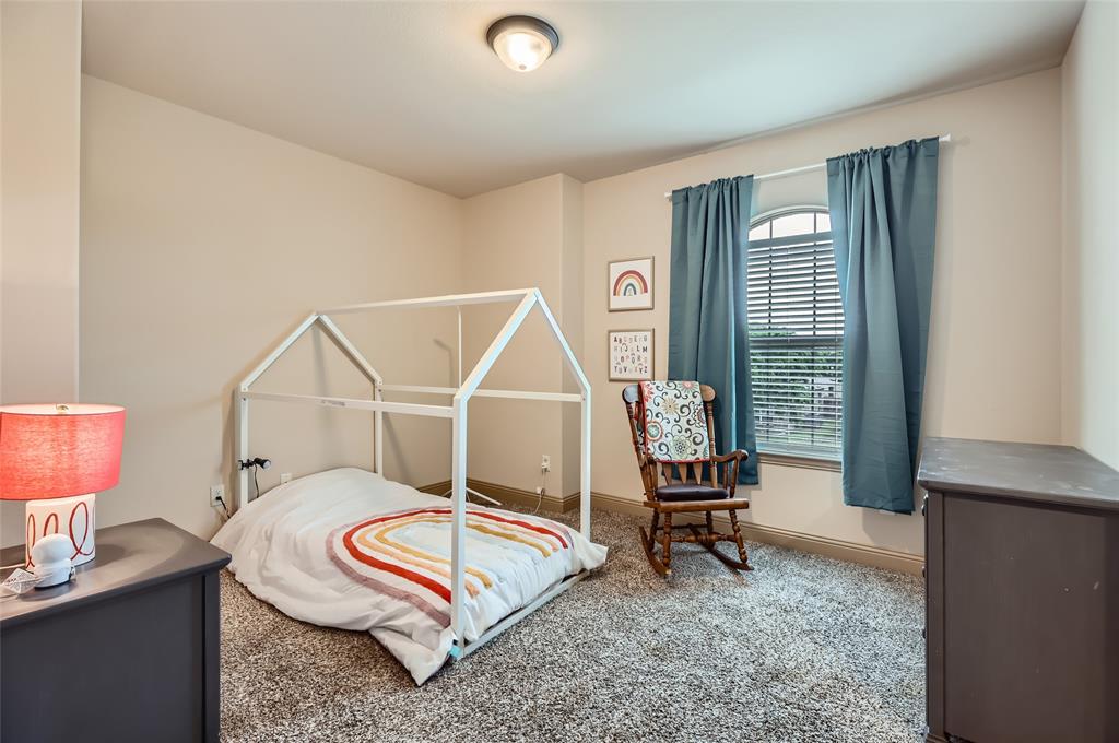 813 Goose Court Forney, TX 75126 - Photo 19 of 28 a living room with furniture a rug and a lamp