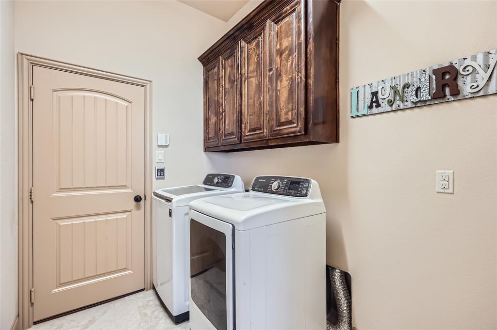 813 Goose Court Forney, TX 75126 - Photo 25 of 28 a utility room with dryer and washer