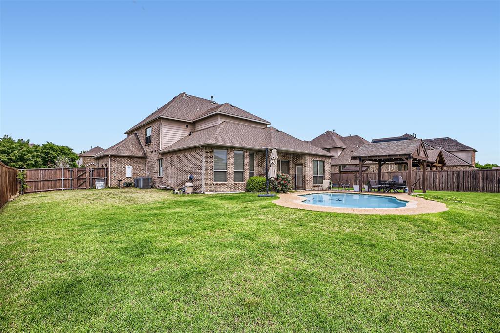 813 Goose Court Forney, TX 75126 - Photo 28 of 28 a view of a house with a big yard and large trees