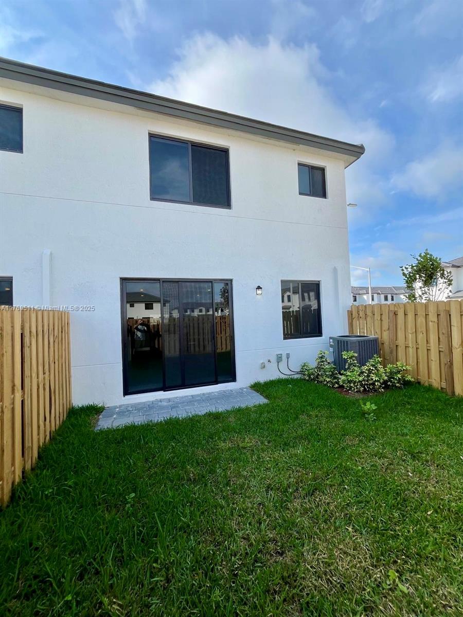 18995 Southwest 345th Terrace Homestead, FL 33034 - Photo 19 of 21 a front view of a house with a yard and garage