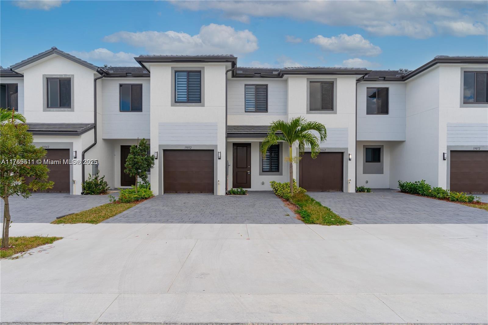 18995 Southwest 345th Terrace Homestead, FL 33034 - Photo 20 of 21 a front view of a house with a yard and a garage