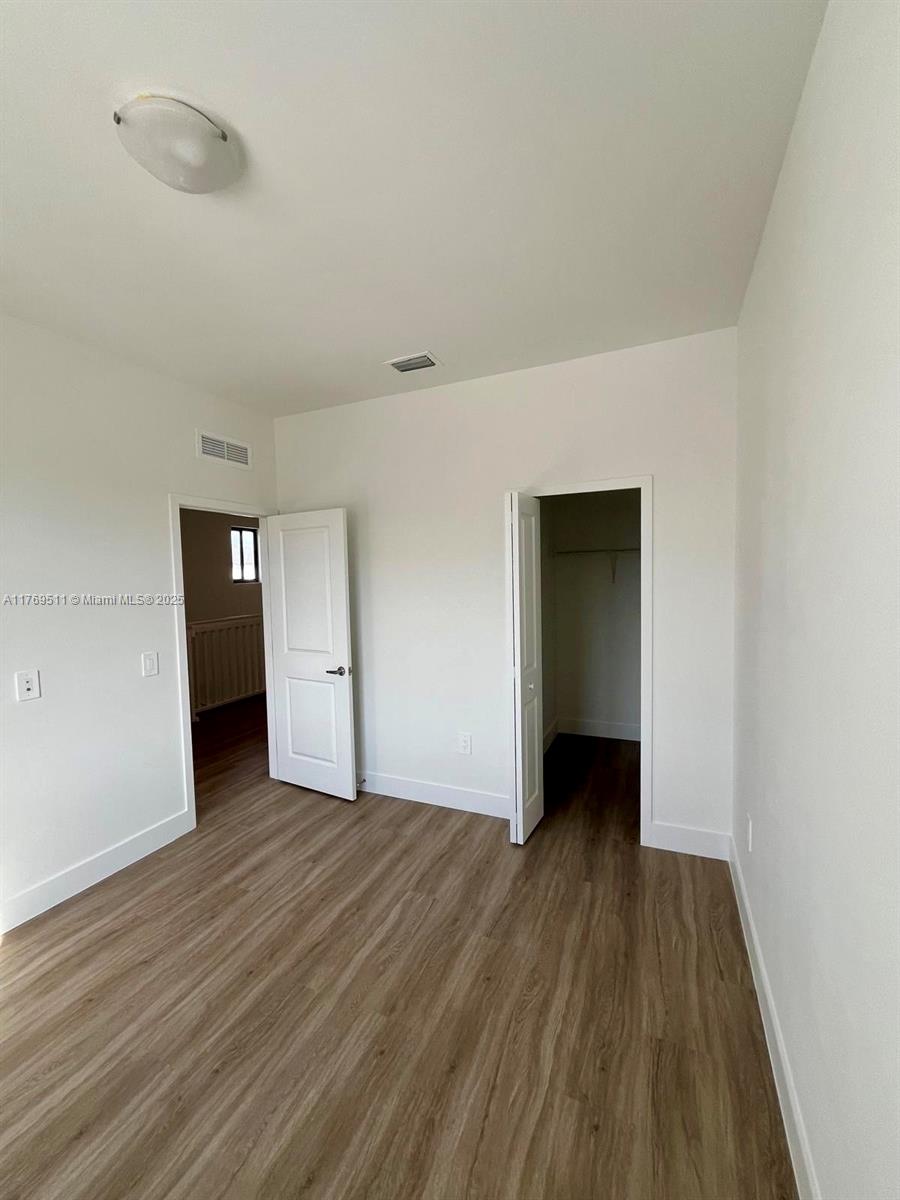 18995 Southwest 345th Terrace Homestead, FL 33034 - Photo 6 of 21 a view of an empty room with wooden floor