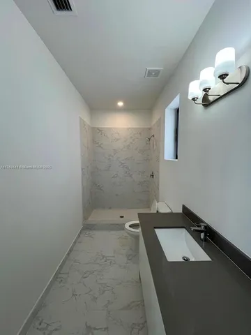 a bathroom with a sink a mirror and a shower