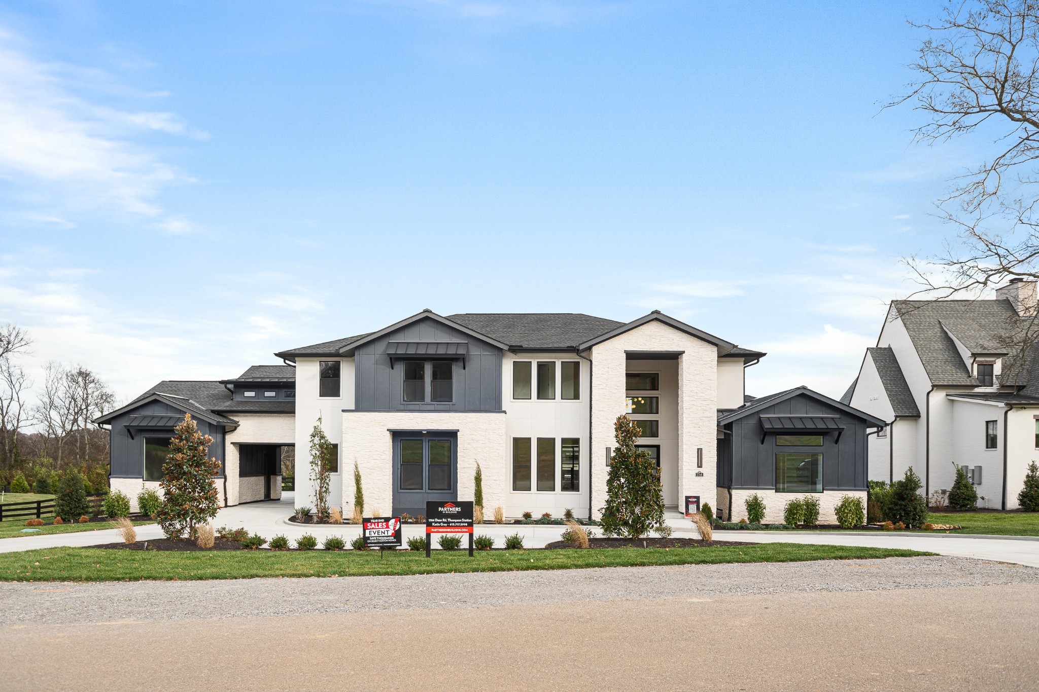 a front view of multiple houses with yard