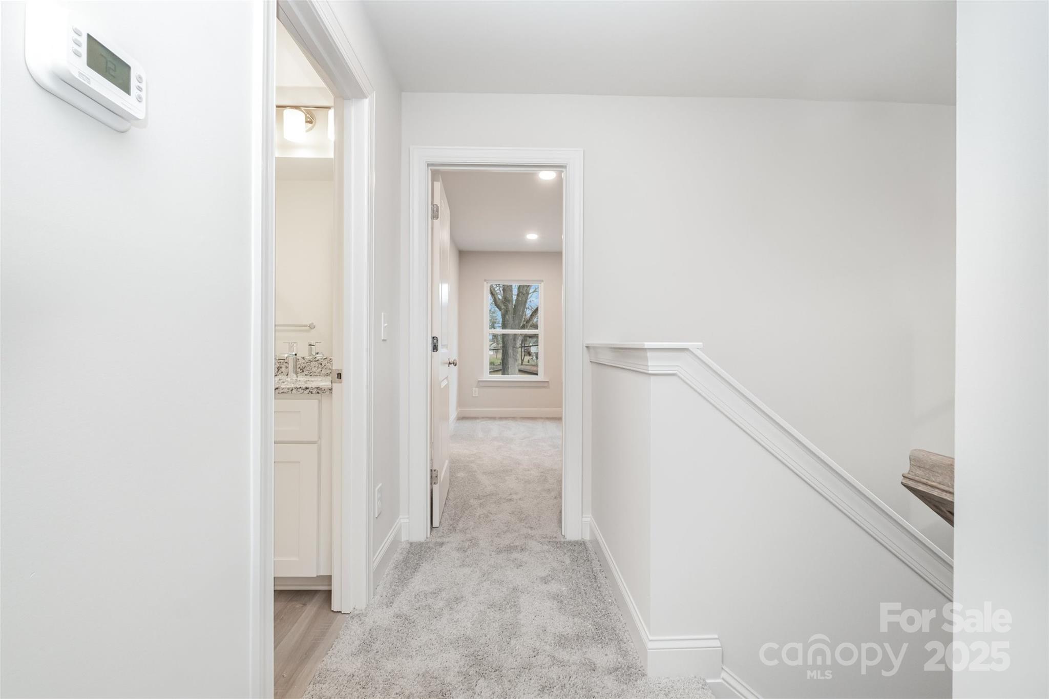 19901 Burton Lane Cornelius, NC 28031 - Photo 11 of 28 a view of a hallway with wooden floor and a bathroom