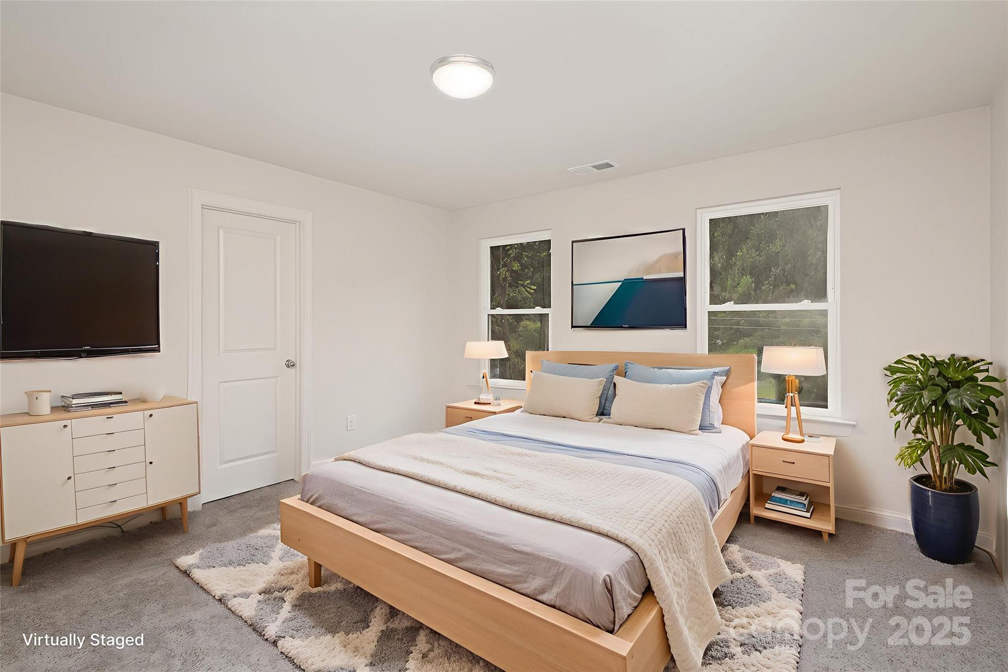 19901 Burton Lane Cornelius, NC 28031 - Photo 12 of 28 a bedroom with a bed and a flat screen tv