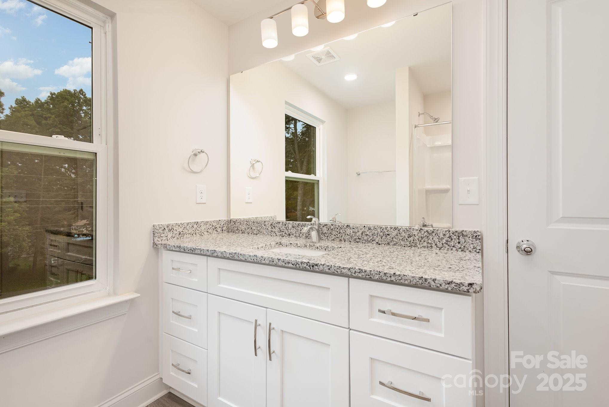 19901 Burton Lane Cornelius, NC 28031 - Photo 14 of 28 a bathroom with a granite countertop sink and a mirror