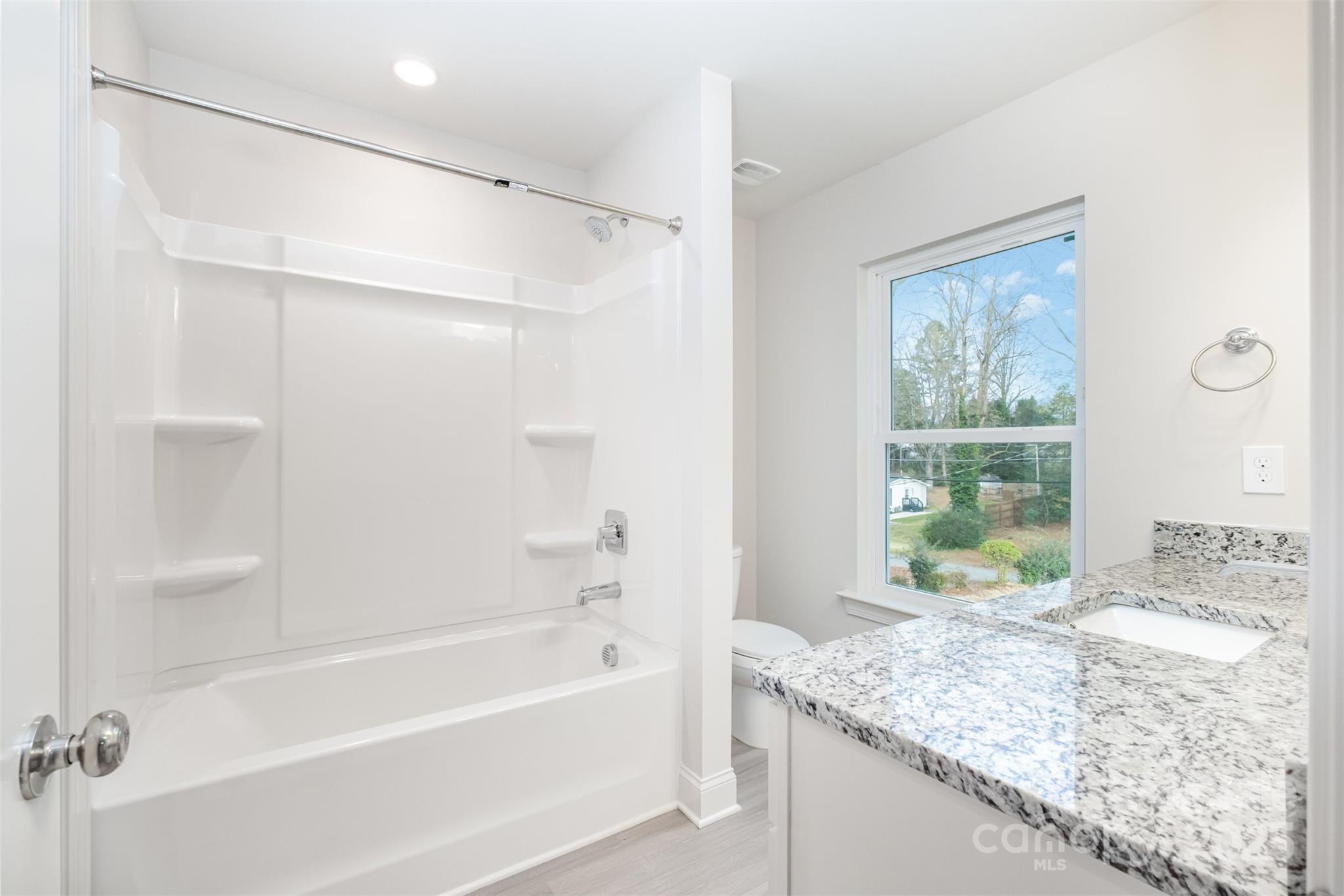 19901 Burton Lane Cornelius, NC 28031 - Photo 15 of 28 a bathroom with a granite countertop sink and a bathtub