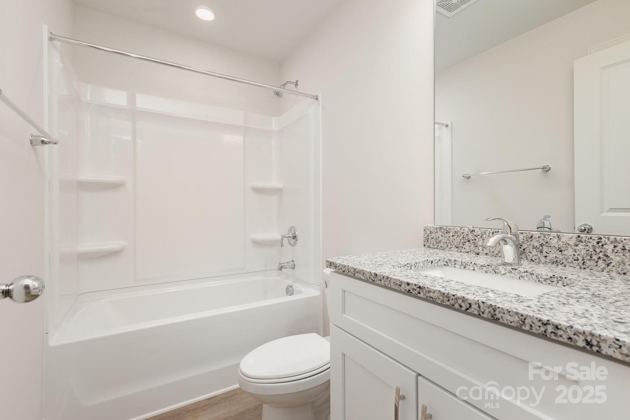 19901 Burton Lane Cornelius, NC 28031 - Photo 21 of 28 a bathroom with a granite countertop sink toilet and shower