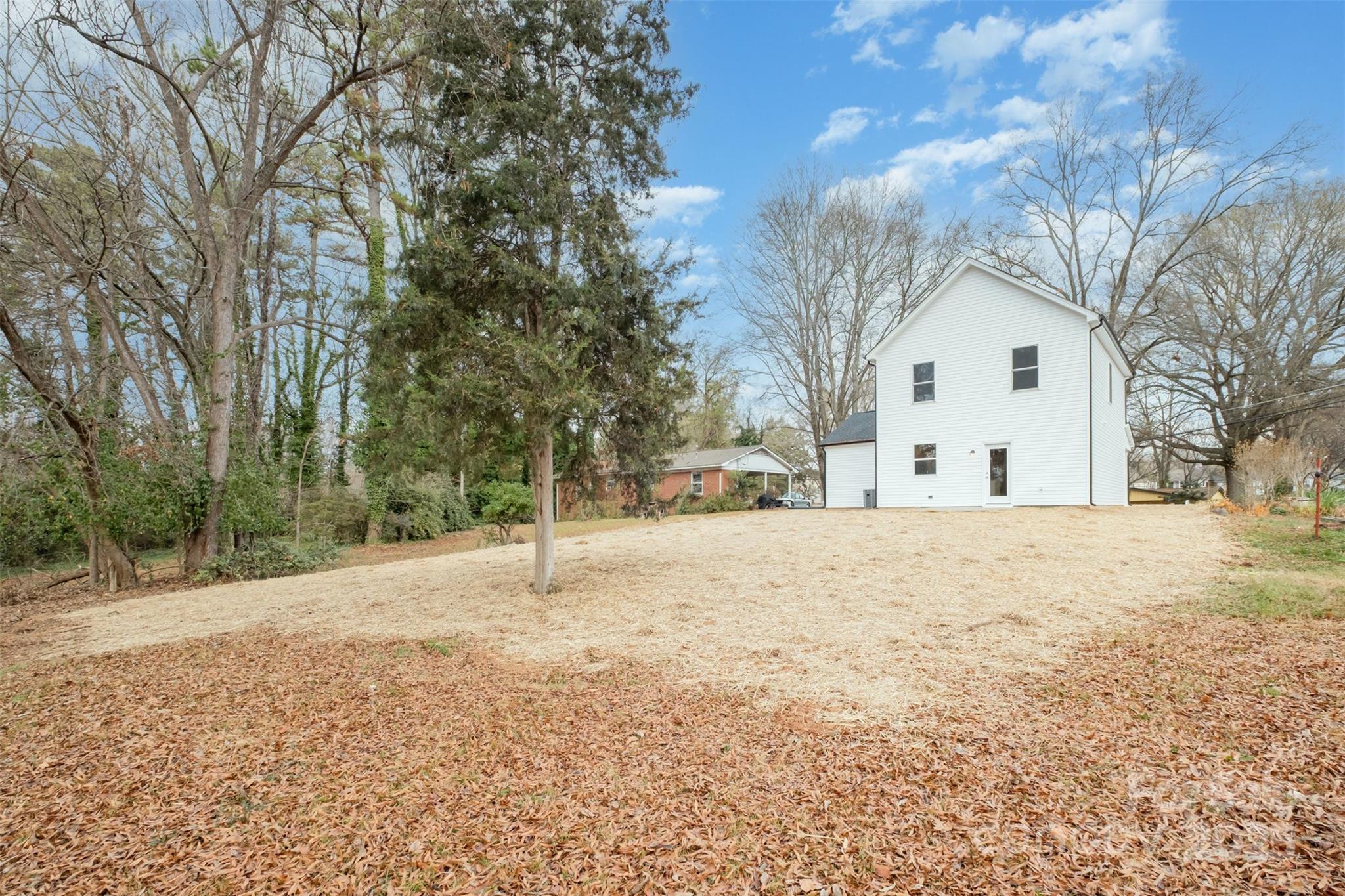 19901 Burton Lane Cornelius, NC 28031 - Photo 25 of 28 a white house that has a tree in front of it