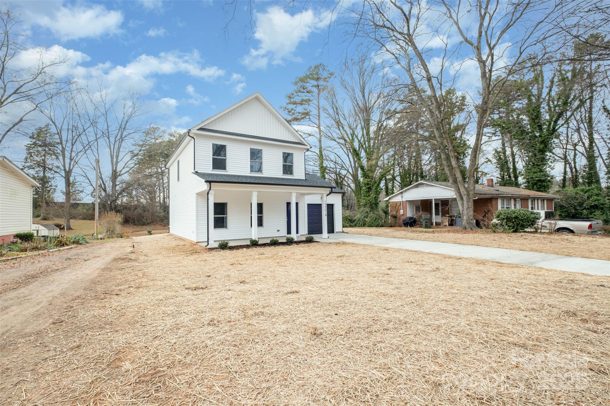19901 Burton Lane Cornelius, NC 28031 - Photo 26 of 28 a front view of a house with a yard and covered with trees