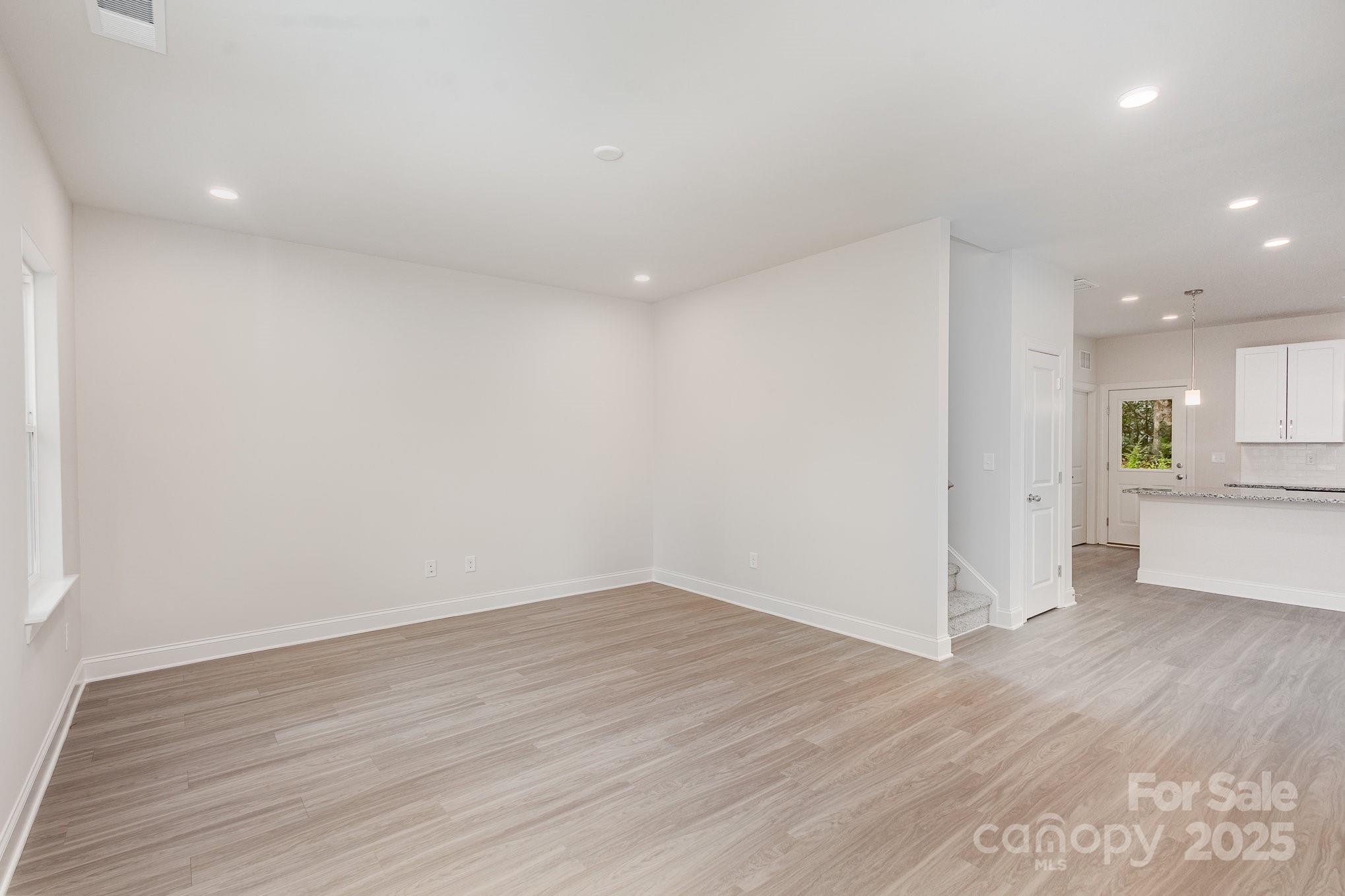 19901 Burton Lane Cornelius, NC 28031 - Photo 3 of 28 a view of a big room with wooden floor and windows