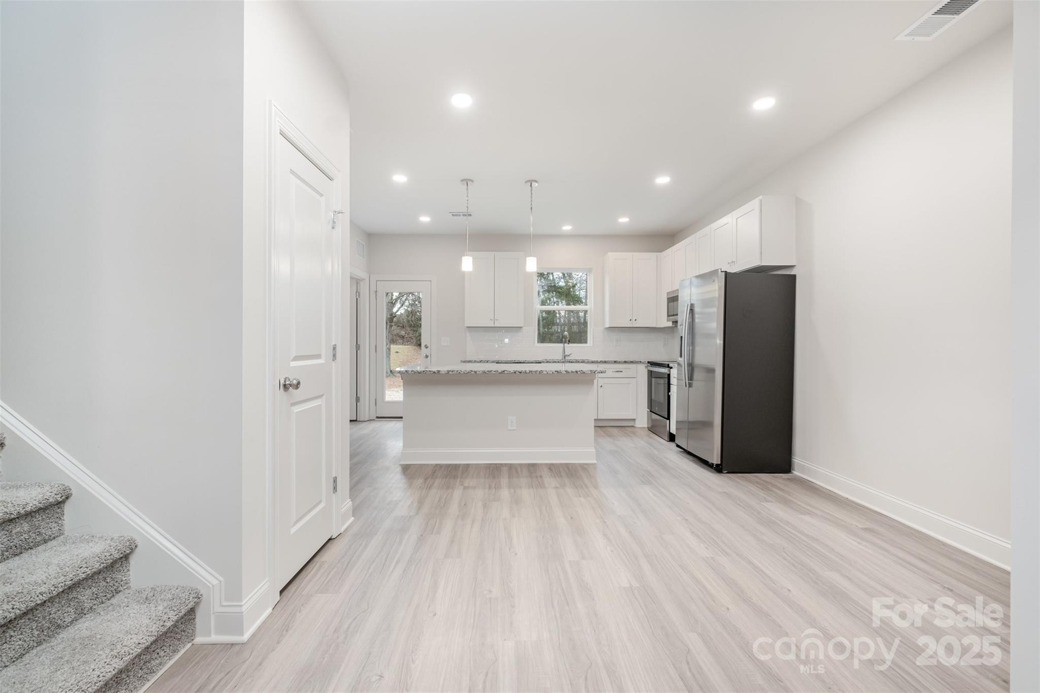 19901 Burton Lane Cornelius, NC 28031 - Photo 5 of 28 a large white kitchen with a refrigerator a sink and a stove