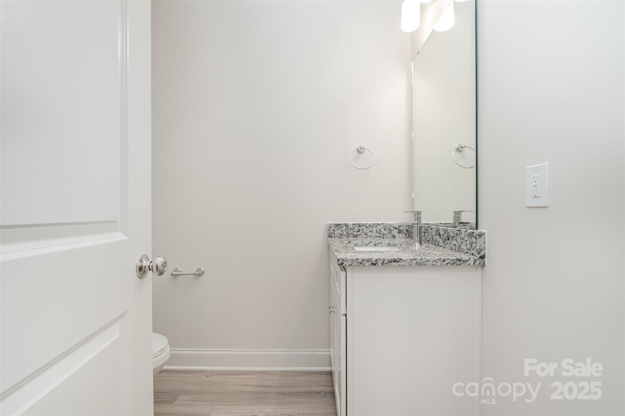 19901 Burton Lane Cornelius, NC 28031 - Photo 10 of 28 a bathroom with a granite countertop sink a mirror and shower