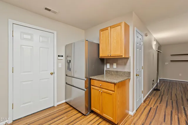 a kitchen with a refrigerator and a sink