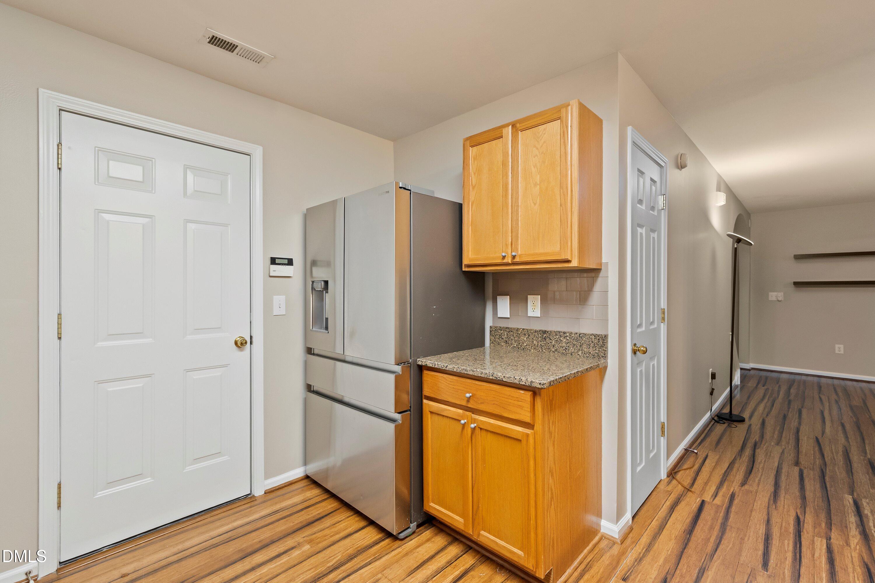 11 Kinglet Court Durham, NC 27713 - Photo 14 of 32 a kitchen with a refrigerator and a sink