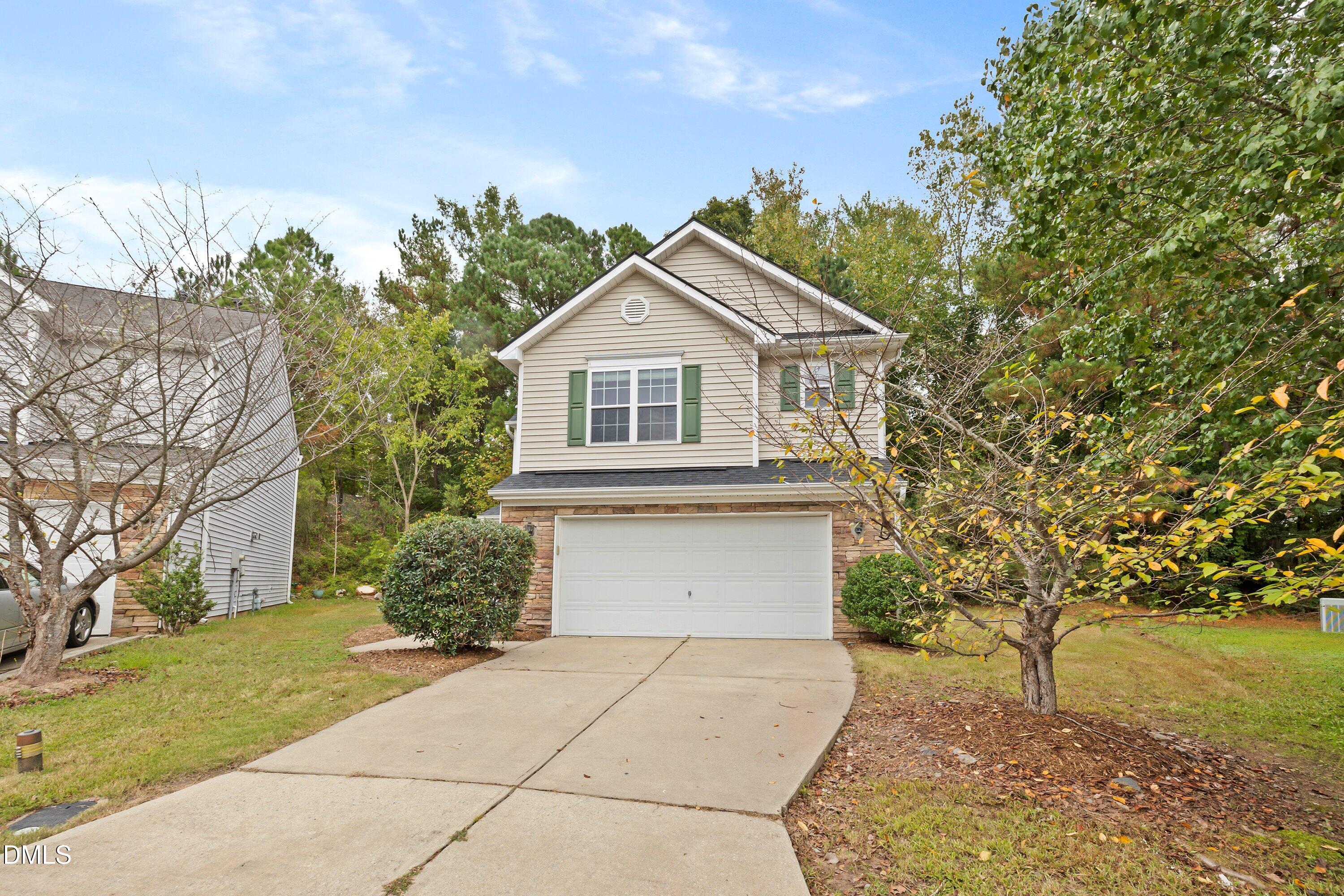 11 Kinglet Court Durham, NC 27713 - Photo 2 of 32 a front view of a house with a yard and trees