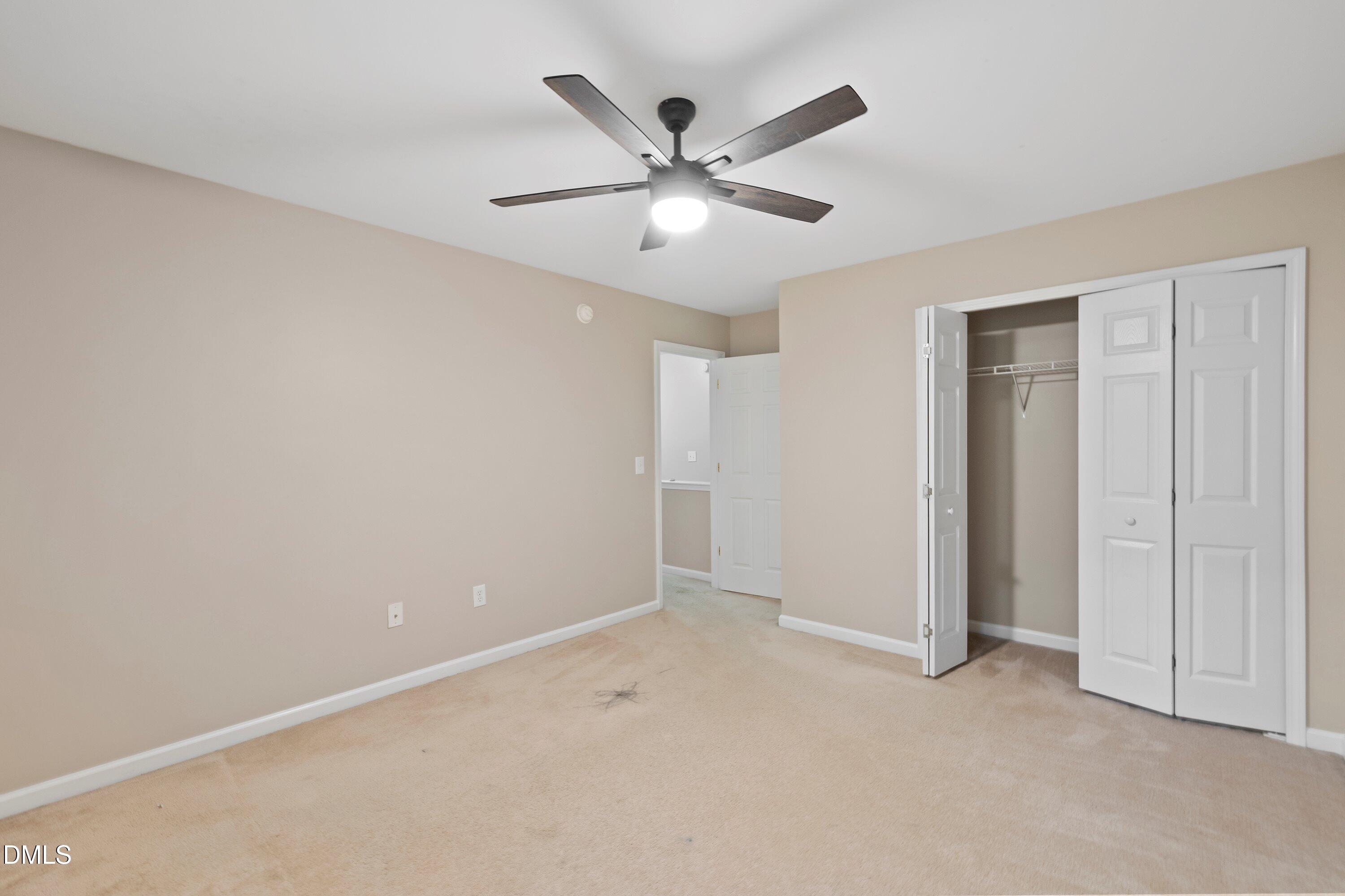 11 Kinglet Court Durham, NC 27713 - Photo 24 of 32 an empty room with closet and ceiling fan