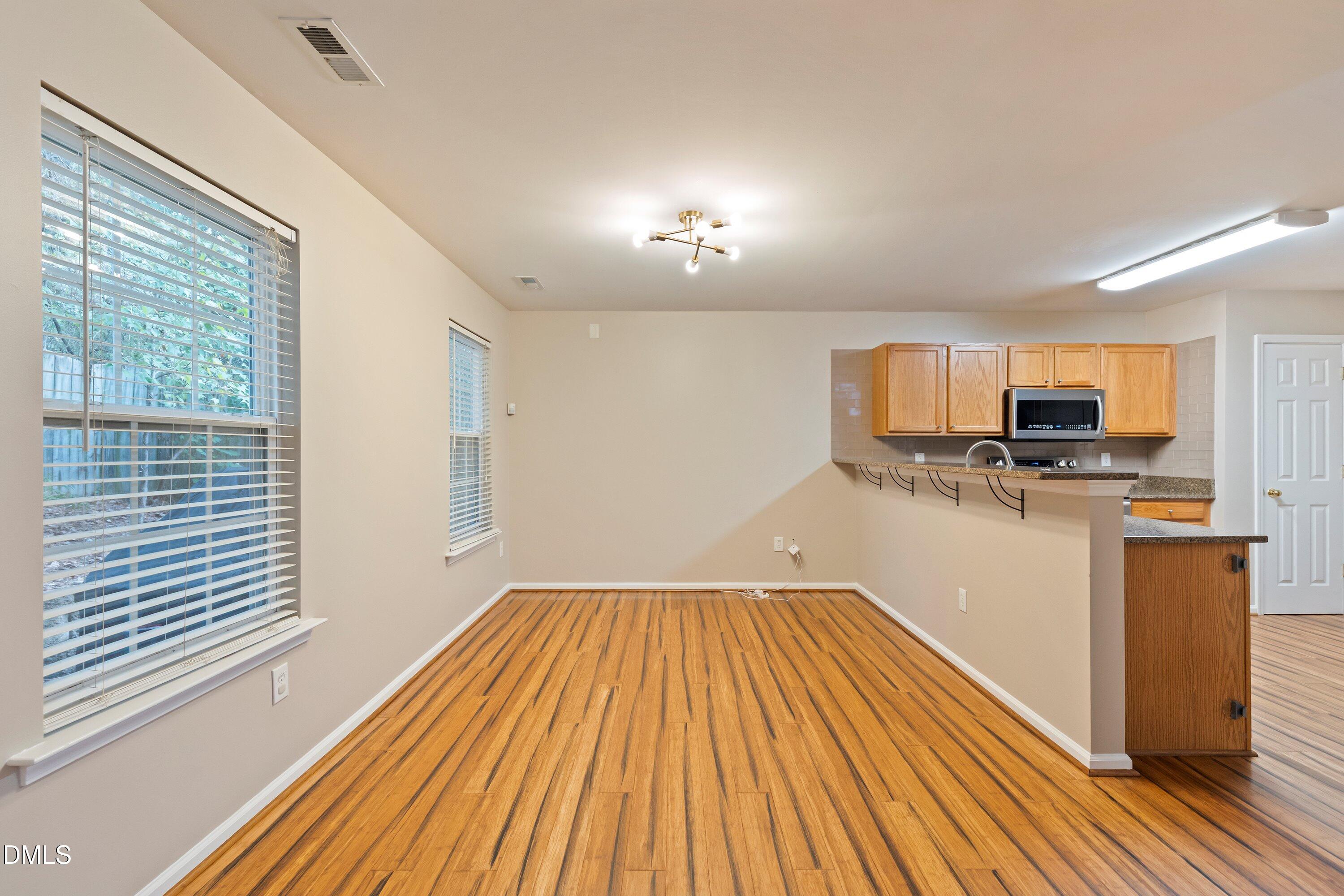 11 Kinglet Court Durham, NC 27713 - Photo 8 of 32 a view of a kitchen with wooden floor and electronic appliances