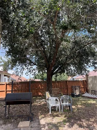a backyard of a house with table and chairs