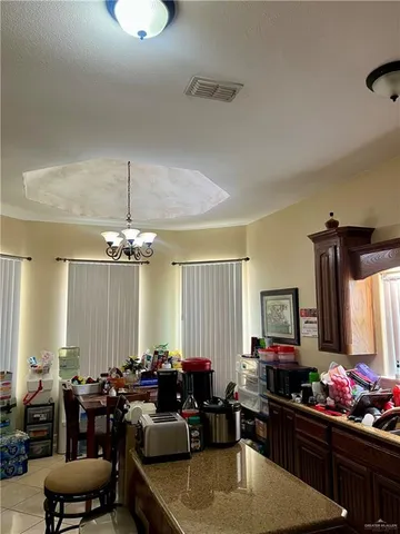 a room with gym equipment and a chandelier