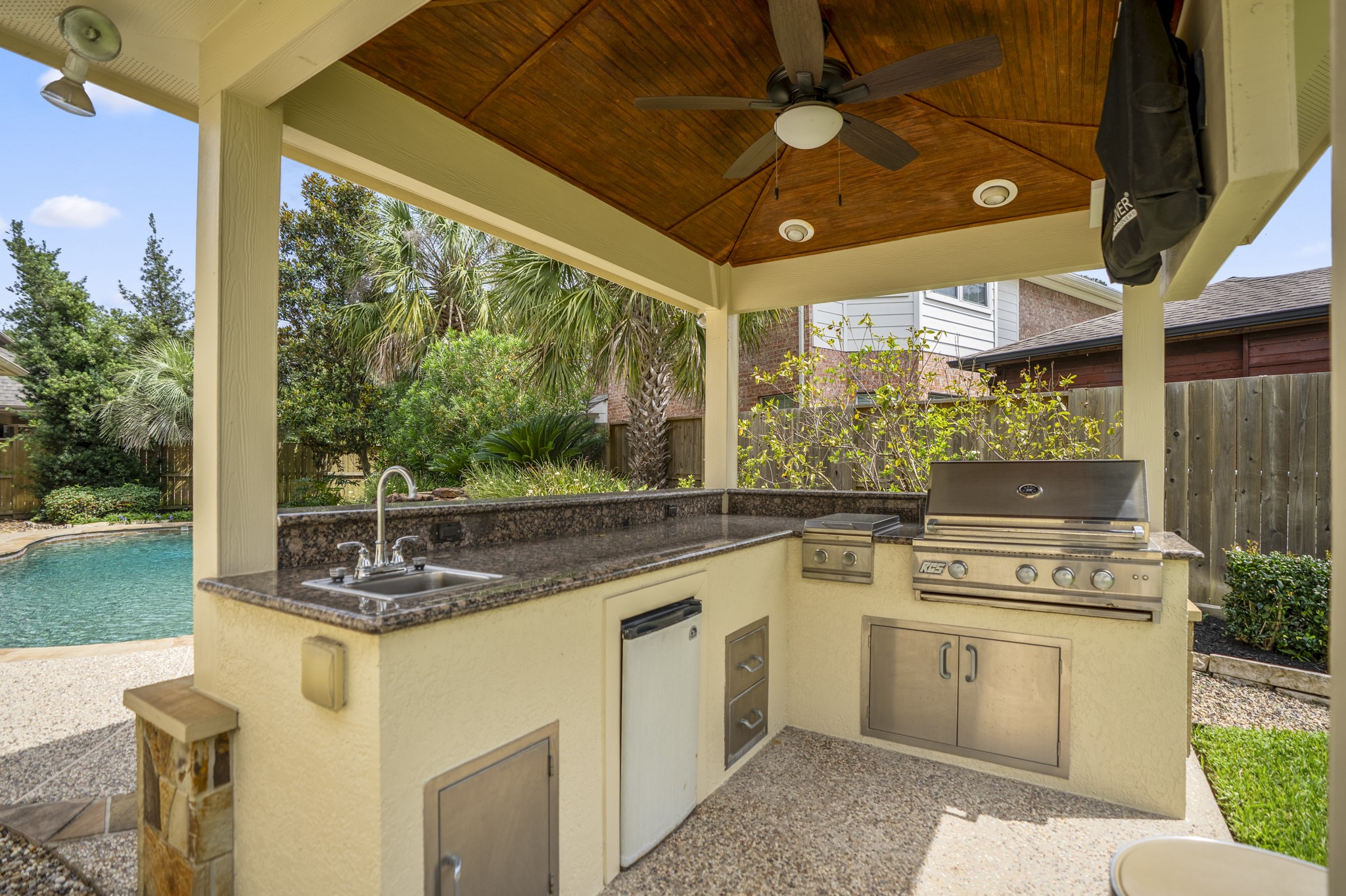 1438 Hatchmere Place Spring, TX 77379 - Photo 36 of 50 Enjoy outdoor living all year round with this detached covered outdoor kitchen; ideal for grilling for family and friends, with grill, sink, fridge and overhead fan.