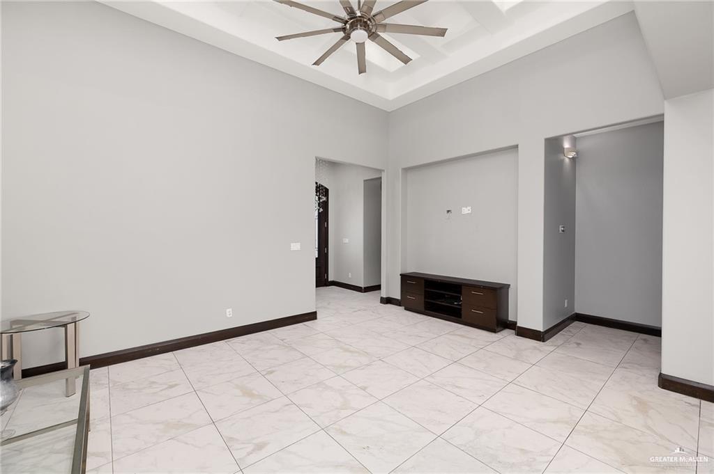 1509 Leandro Street Mission, TX 78574 - Photo 2 of 11 an empty room with fireplace and fan