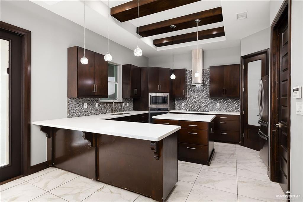1509 Leandro Street Mission, TX 78574 - Photo 5 of 11 a large kitchen with a sink and refrigerator