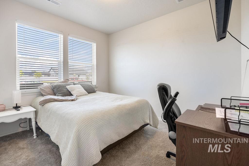 4601 Great Fls Avenue Caldwell, ID 83607 - Photo 15 of 29 Carpeted room with white walls, two windows featuring horizontal blinds, and a ceiling-mounted light fixture