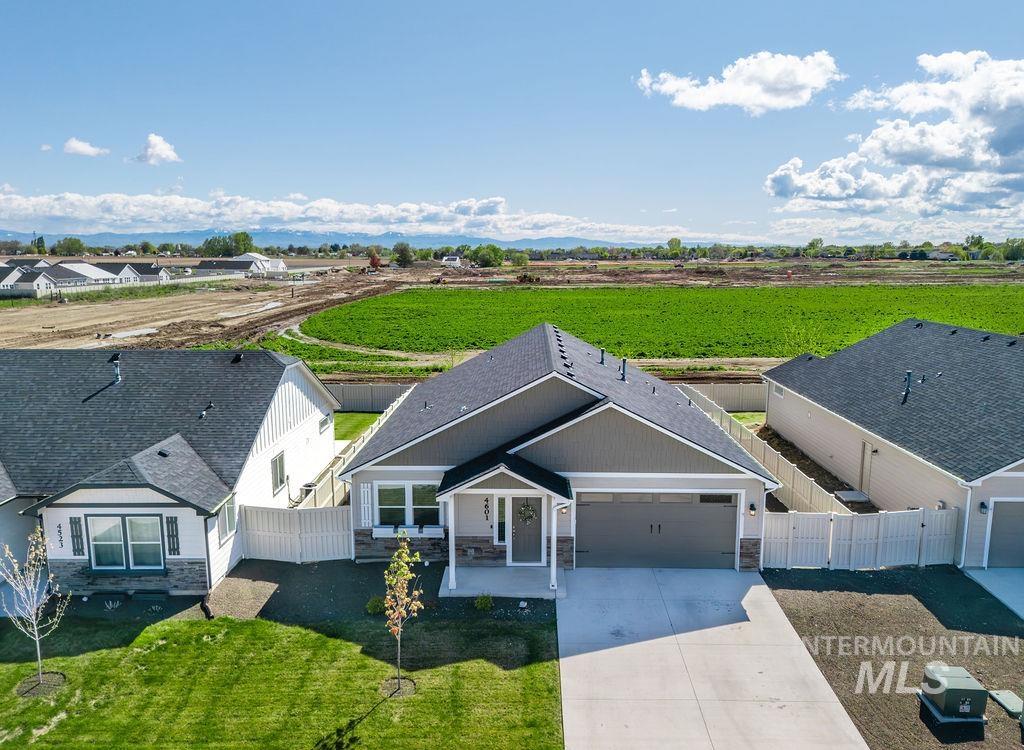 4601 Great Fls Avenue Caldwell, ID 83607 - Photo 2 of 29 Contemporary ranch-style home featuring a two-car garage, stone and horizontal siding exterior, and a covered front porch