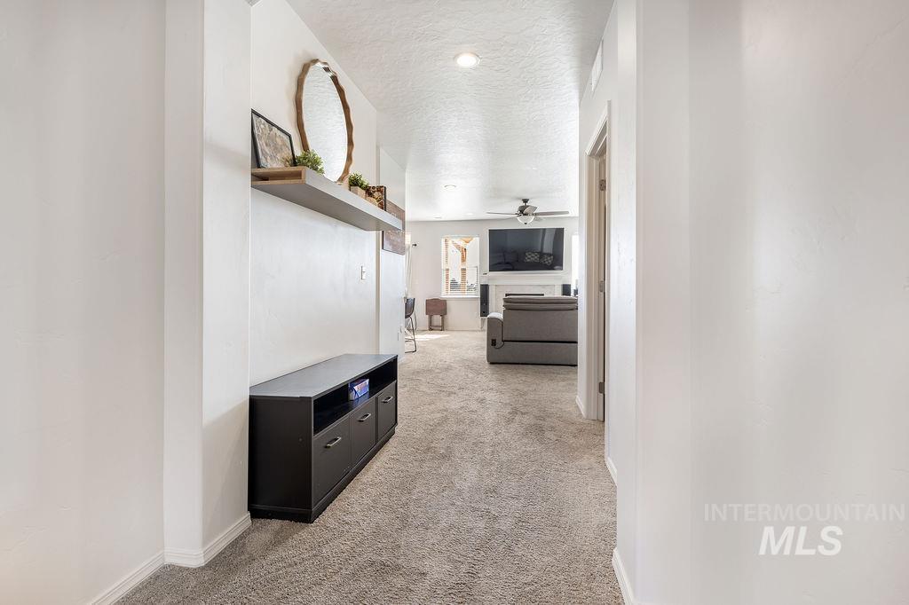 4601 Great Fls Avenue Caldwell, ID 83607 - Photo 21 of 29 Hallway with light-colored carpet flooring and white walls