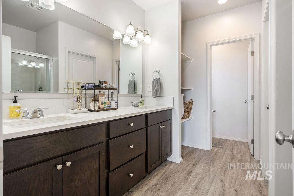 4601 Great Fls Avenue Caldwell, ID 83607 - Photo 24 of 29 Dual vanity with dark wood-finish cabinetry and light countertops
