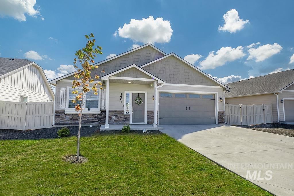 4601 Great Fls Avenue Caldwell, ID 83607 - Photo 29 of 29 Contemporary residence featuring a two-car garage, stone and siding exterior, front porch entry, concrete driveway, and a manicured lawn