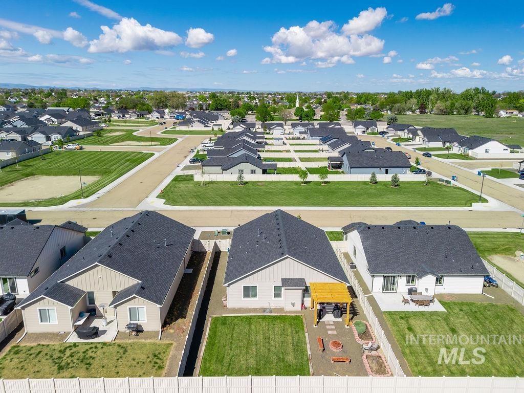 4601 Great Fls Avenue Caldwell, ID 83607 - Photo 3 of 29 Aerial perspective showcasing a residential community with single-story homes, paved streets, and green spaces