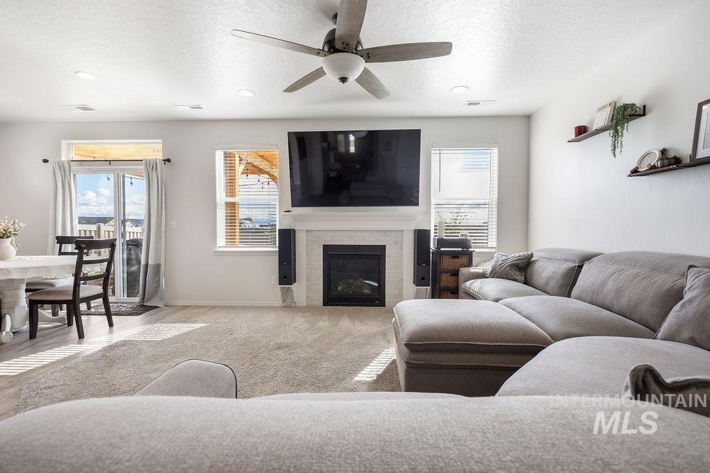 4601 Great Fls Avenue Caldwell, ID 83607 - Photo 7 of 29 Spacious living area featuring light-toned carpet flooring and a built-in fireplace with a mantel