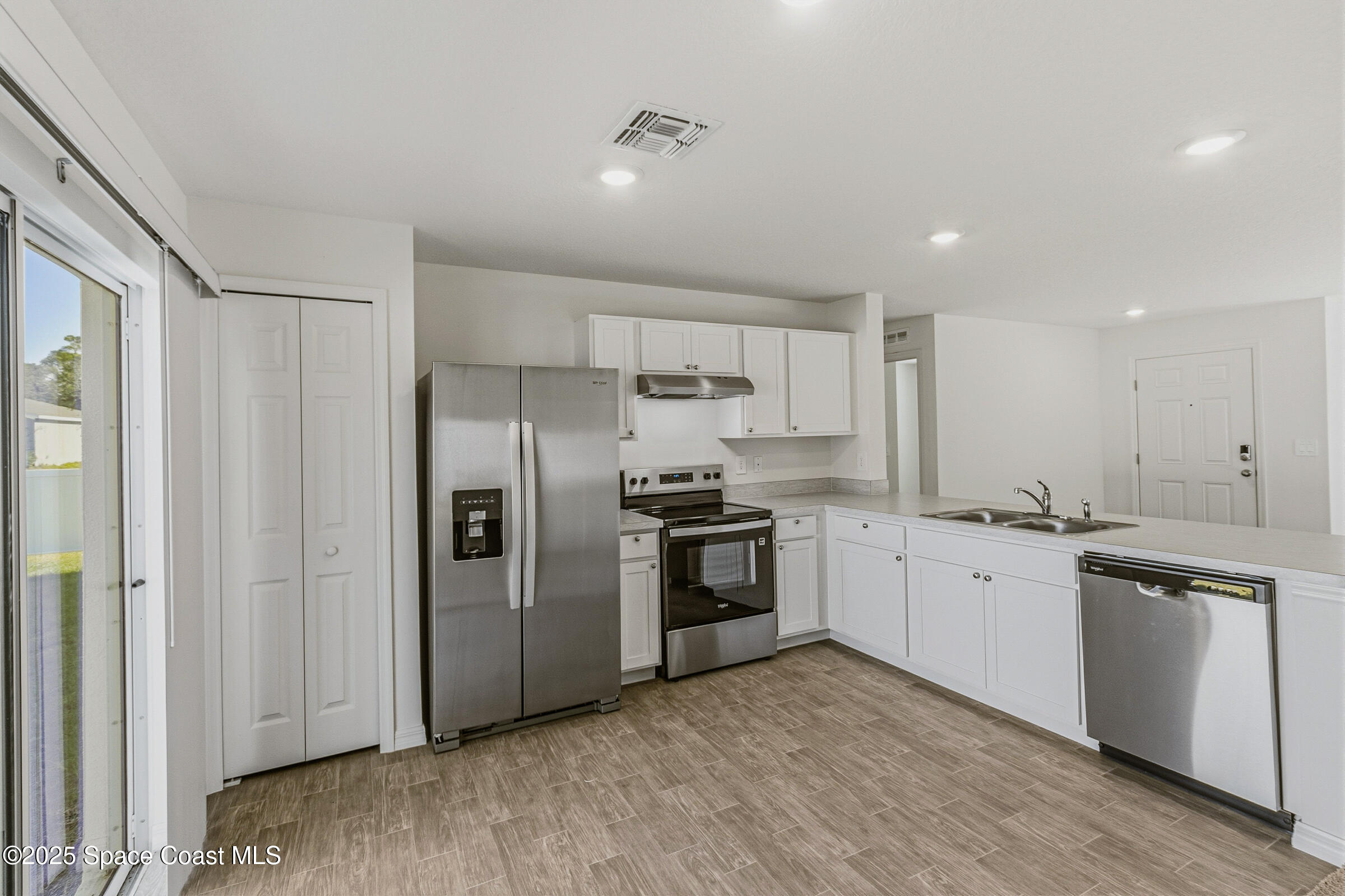 511 Trumpet Street Southwest Palm Bay, FL 32908 - Photo 16 of 43 a kitchen with granite countertop a refrigerator stove top oven and sink