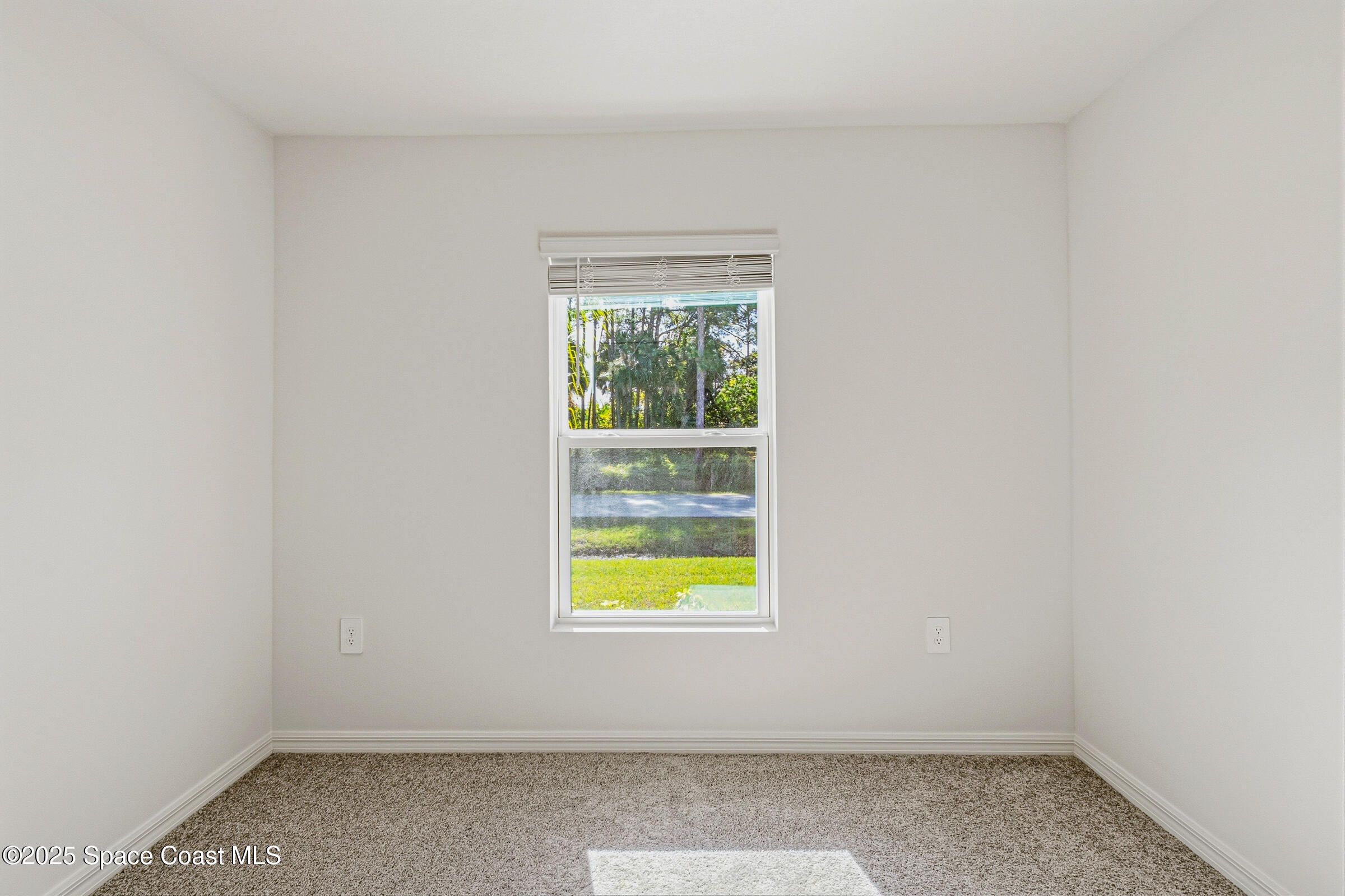 511 Trumpet Street Southwest Palm Bay, FL 32908 - Photo 18 of 43 an empty room with a window