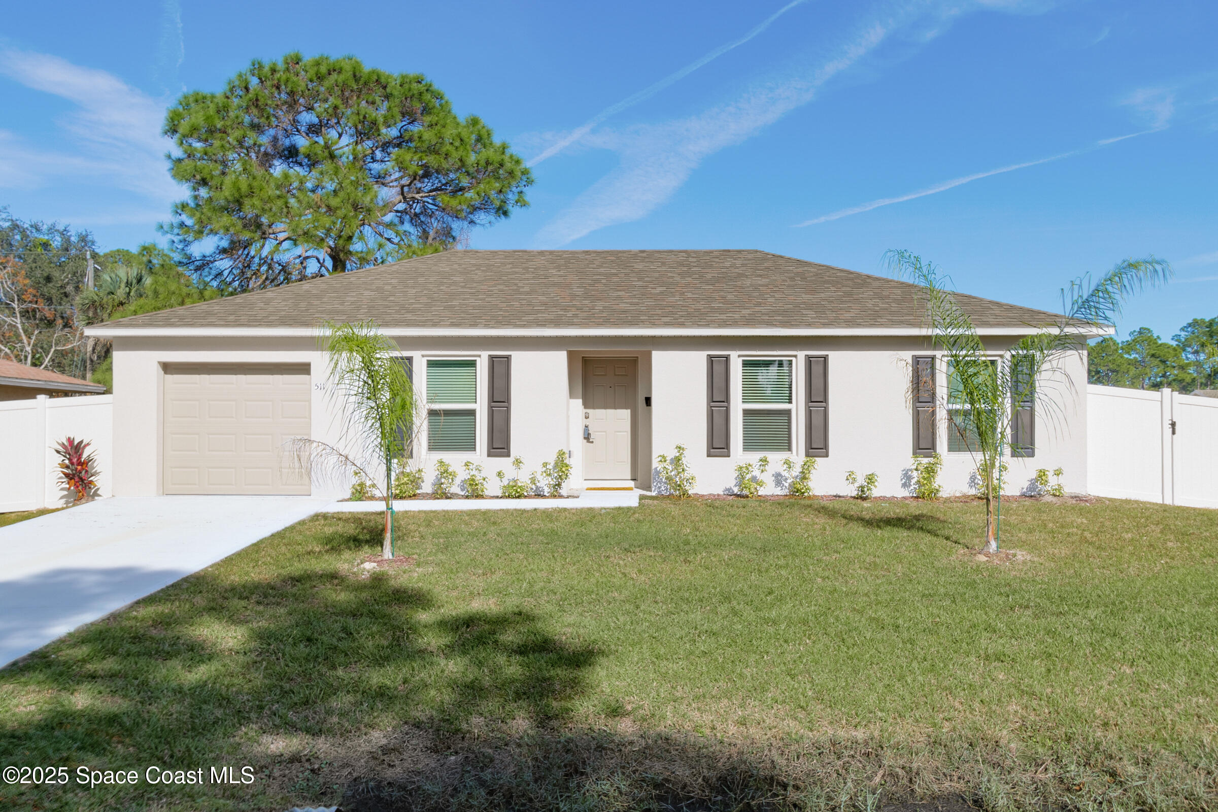 511 Trumpet Street Southwest Palm Bay, FL 32908 - Photo 3 of 43 a front view of a house with a garden
