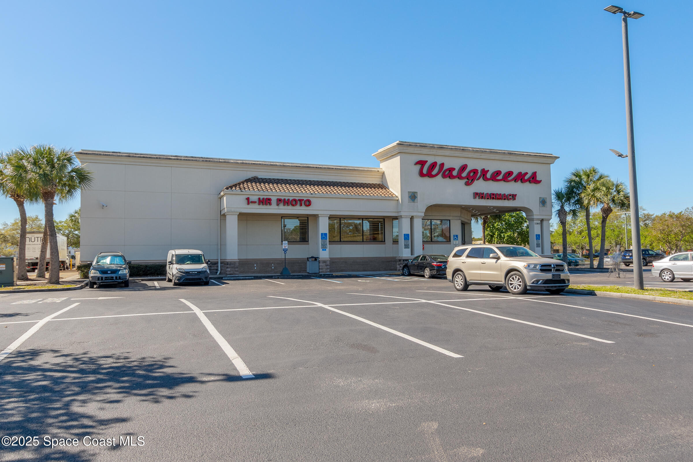 511 Trumpet Street Southwest Palm Bay, FL 32908 - Photo 35 of 43 a view of a cars parked in front of a building