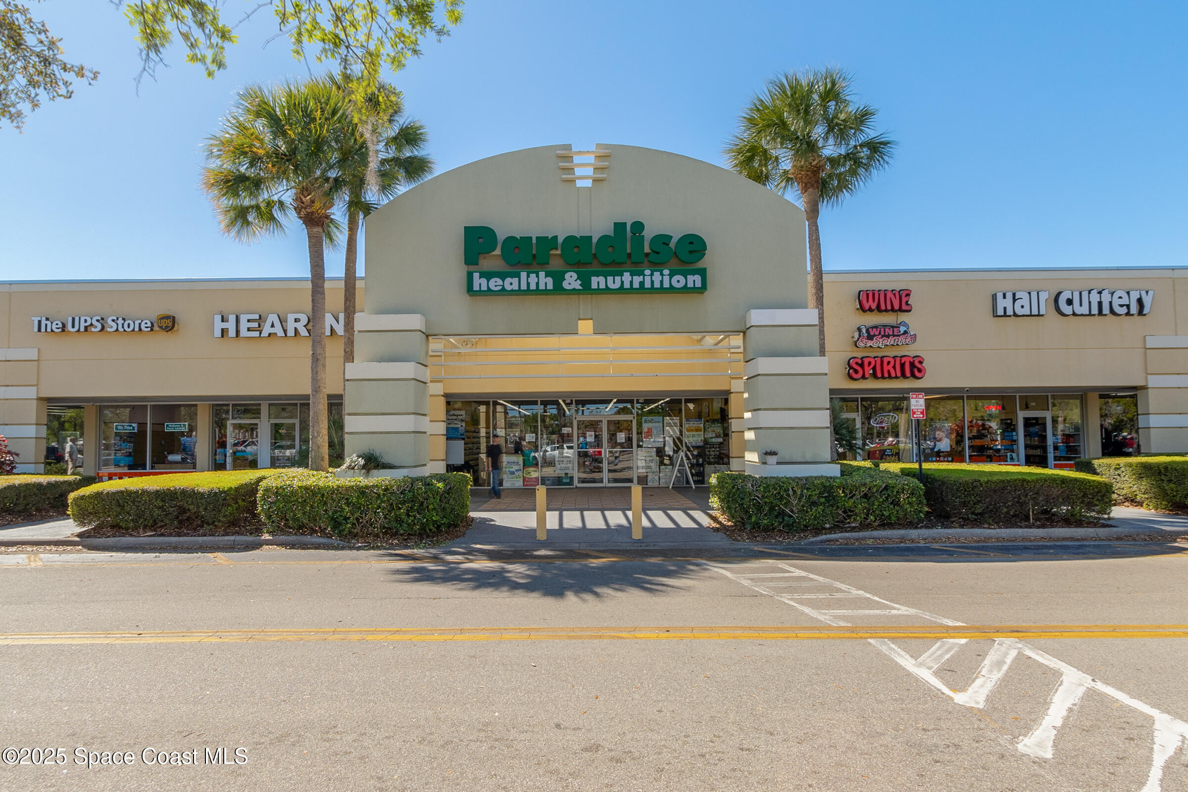 511 Trumpet Street Southwest Palm Bay, FL 32908 - Photo 42 of 43 a front view of a building with garden and parking