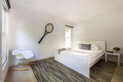 a bedroom with a bed and window