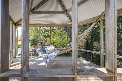 a view of a house with backyard and porch